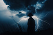 the lone cowboy standing with lightning behind him in silhouette stock photo