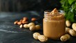 Recently prepared smooth Peanut Butter in a glass container