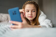 nhappy Teenage Girl With Mobile Phone Lying On Bed At Home Anxious About Social Media Online Bullying And Using Phone Too Much