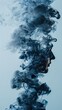 Side profile of a persons face partially obscured by swirling blue smoke against plain background