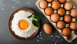 Wheat flour and chicken eggs on dark cooking background. Culinary and baking concept. Flat lay.