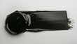 photo of wet dark lino ink remain, black linocutting paint roller texture isolated on white paper background.