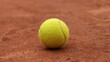 a tennis ball sits on a tennis court, ready to serve the ball