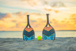 Beach tennis racket and ball on the sandy beach.. Background with copy space. Sport court at the beach and ball. Summer sport concept