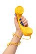 © Nikolay - Yellow handset in woman hand isolated on white. Copy space.