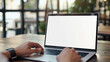 © Synthetica - Business person working online or learning using laptop mock up blank white empty screen, hands typing on computer background close up view. Mockup display for ads. Close up view.
