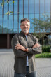 © Stock 4 You - Lifestyle portrait of European middle age mature adult man. Freelancer entrepreneur standing outdoor at street. Happy handsome 40 years old latin hispanic businessman smiling at camera with sun ray