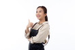 Portrait smiling young asian woman wearing apron showing thumbs up with hand isolated white background, young asian woman making thumbs up gesture, waitress or entrepreneur, small business or startup.