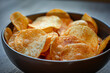 A bowl of crispy, golden chips, emphasizing their appeal as a beloved snack - Generative AI