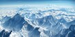 © pham - A view of a mountain range from an airplane, showcasing the rugged peaks and valleys below