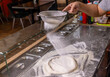 Sift flour by sieve with the flour for beating up dough, pizza. Hands to rub flour. Process of making pizza. Professional chef in a kitchen prepares dough from flour to cook Italian pasta, pizza