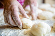 Baking at home. Homemade cakes dough in the women's hands. Process of making pies, hand. Hands pie dough. Cooks dough for baking, pieces of raw dough. Womans hands rolling doughs for pies