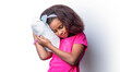 Healthy baby's sleep. Children girl is sleeping a pillow on a white background. African kid girl sleeps in cushion. Morning little girl - pillow, cushion. Little girl sleeps sweetly in bed