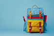 Colorful textile backpack with school supplies