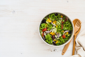 bowl of fresh salad with vegetables on white wood rustic background