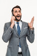 Vertical shot of amazed young businessman talking by the phone and hearing good news isolated over white background. Fortune, winning, discount sale offer concept