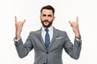 Active young businessman showing rock-n-roll gesture isolated over white background. Cheerful music rock lover fan looking at the camera, dreaming of a concert