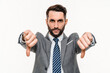 Angry young businessman showing thumbs down isolated over white background. Caucasian man manager expressing disbelief disagreement bad quality concept