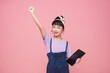 smiling young Asian girl holding tablet computer with hand up happy isolated on pink background.