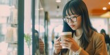 Fototapeta  - Asian woman drinking coffee in a cafe
