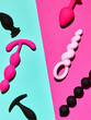 sex toys background. anal plugs and dildo over blue and pink backdrop