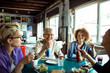 © Davor - Diverse group of women of different age eating lunch at office
