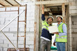 © offsuperphoto - workers or architects working on laptop computer and pointing up to something at construction site