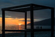 A wooden structure with a view of the ocean and a sunset