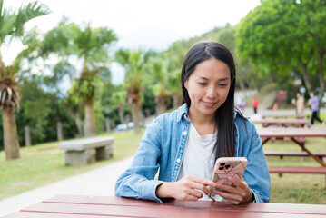 Wall Mural - Woman use mobile phone at outdoor