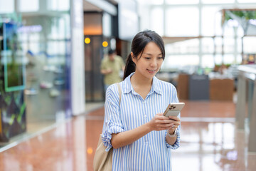 Wall Mural - Woman use smart phone in shopping mall