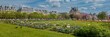 Panoramic view of the vibrant Tuileries Garden in spring with blooming flowers and Parisian architecture, perfect for travel and Earth Day themes