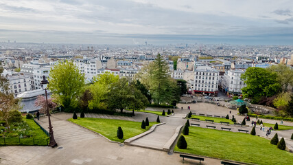 Wall Mural - Breathtaking panoramic view of Paris from Montmartre with lush greenery and urban landscape, ideal for travel and tourism themes related to European cities