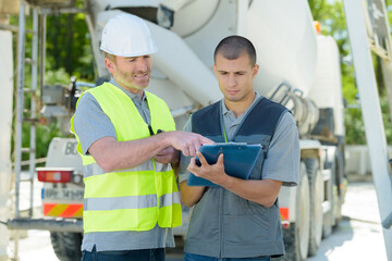 cement delivery worker signing on paper