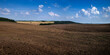 panoramic view of a field with arable land, wavy lines of hills, rural landscapes