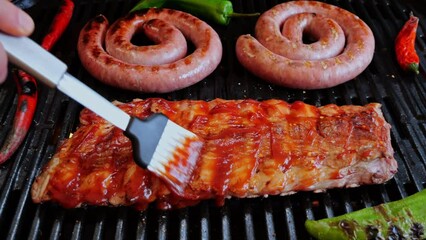 Wall Mural - Chef spread sauce pork ribs On Grill. Cooking natural sausage on grill. Slow motion. Close up