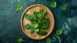 Wooden round plate with fresh spinach leaves top
