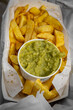 A high angle view of chips and mushy peas being eaten al fresco