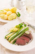 Traditional roasted angus beef steak with white and green asparagus, boild potatoes and sauce hollandaise served as close-up on a classic plate