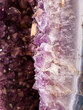 Amethyst geode close up of edge with crystals in background