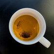 Tea leaf dregs in the bottom of a mug
