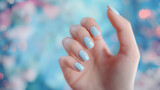 Fototapeta  - Mão de uma mulher com as unhas pintadas de azul claro 