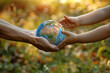 Old hands giving a Earth globe to young hands, symbolic eco gesture, education for environmental protection, human responsibility for nature conservation, Planet care and sustainable development