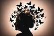Silhouette of senior woman with butterlies around head