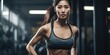 Asian woman confidently stands in a gym, with her hands placed firmly on her hips.