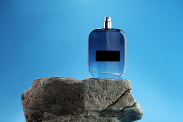 Wall Mural - Stylish presentation of luxury men`s perfume on stone against light blue background