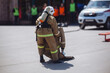 Fireman in uniform is dragging a mannequin on training