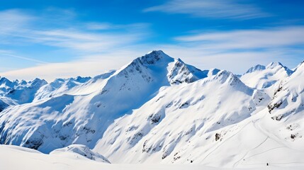 Wall Mural - Panoramic view of snowy mountains and blue sky with white clouds