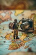 Toy soldier figurine holding a camera on a map. Ideal for travel and adventure concepts