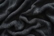 Detailed close up of black knit fabric. Suitable for textile backgrounds
