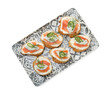 Tasty canapes with salmon, cucumber, cream cheese and dill isolated on white, top view
